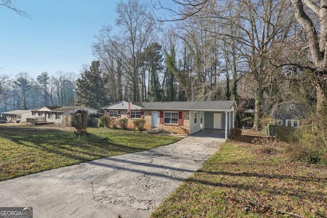 view of front of house with brick siding, crawl space, a front yard, a carport, and driveway