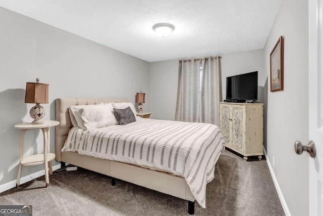 bedroom with carpet, baseboards, and a textured ceiling