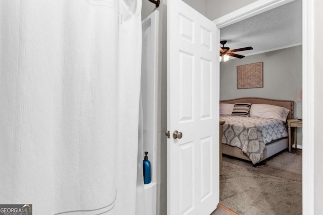 carpeted bedroom with crown molding and a ceiling fan