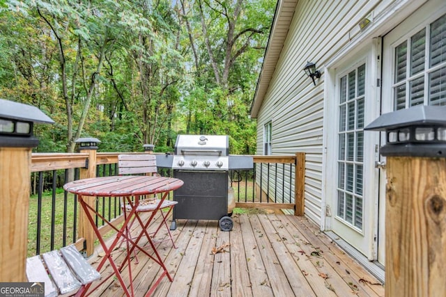 wooden deck with a grill