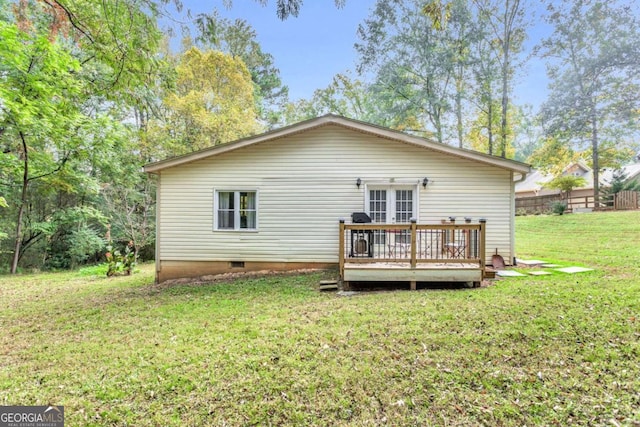 rear view of property with a deck, a yard, french doors, and crawl space