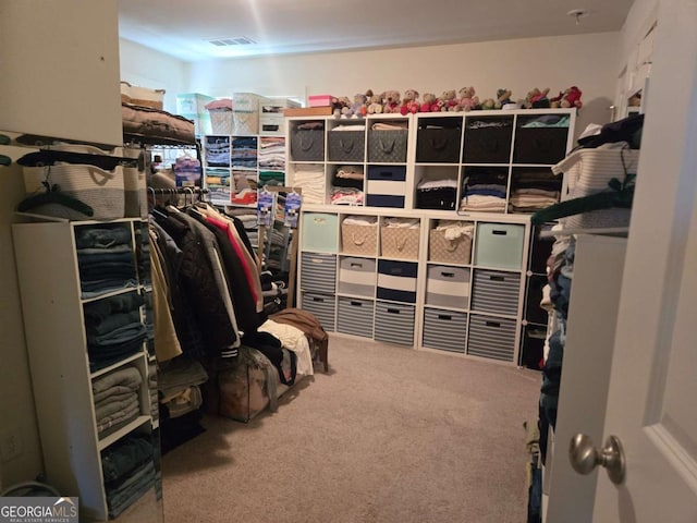 spacious closet with visible vents and carpet