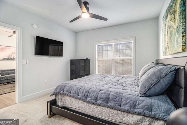 carpeted bedroom with a ceiling fan and baseboards