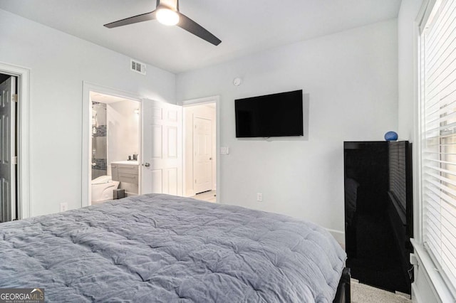 bedroom featuring visible vents, ensuite bath, and ceiling fan