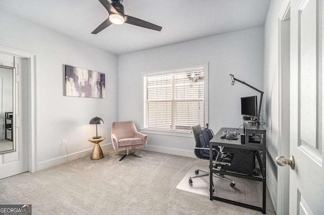 carpeted home office with a ceiling fan and baseboards