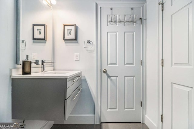 bathroom featuring vanity, baseboards, and tile patterned flooring