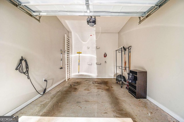 garage with a garage door opener and baseboards