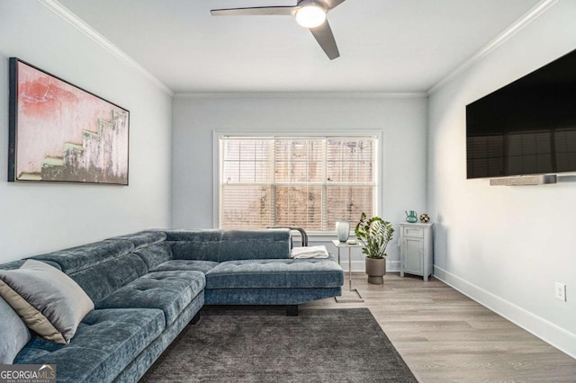 living area with a ceiling fan, baseboards, light wood finished floors, and ornamental molding