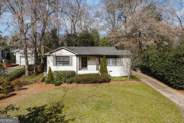 view of front of house with an outbuilding and a front lawn