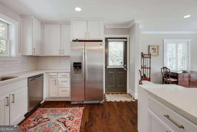 kitchen with plenty of natural light, appliances with stainless steel finishes, and light countertops