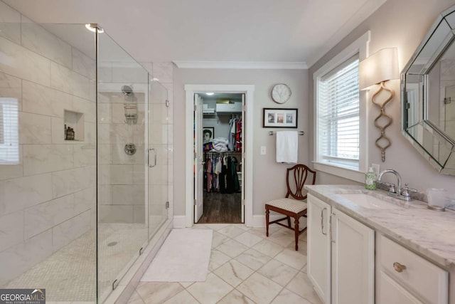 bathroom featuring vanity, baseboards, a stall shower, ornamental molding, and marble finish floor