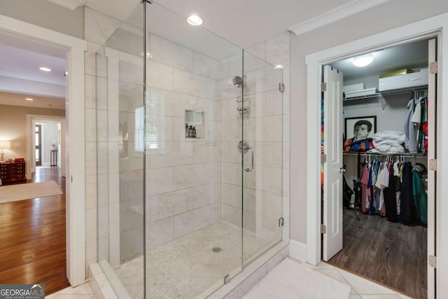 bathroom featuring tile patterned floors, recessed lighting, a stall shower, and a walk in closet