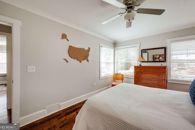 bedroom with baseboards, dark wood-style floors, visible vents, and ornamental molding