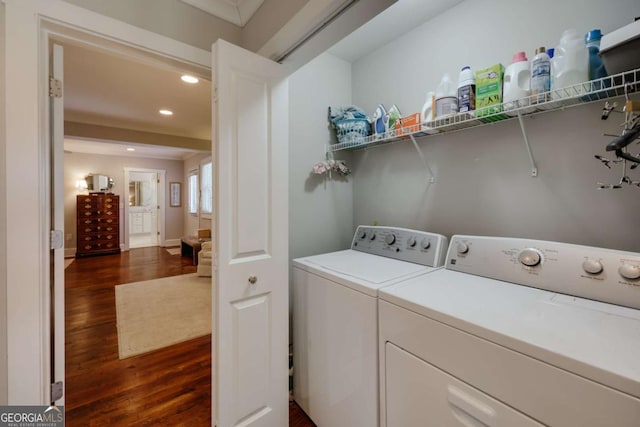 laundry room featuring dark wood-type flooring, washing machine and dryer, recessed lighting, baseboards, and laundry area