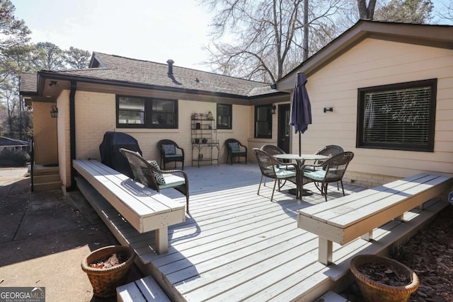 wooden terrace featuring outdoor dining area