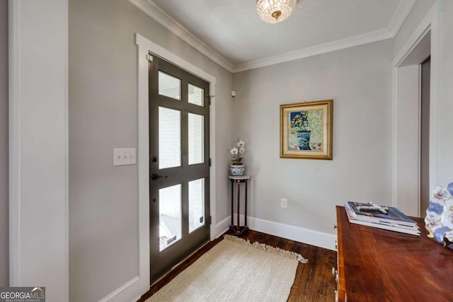 foyer with dark wood-style floors, a healthy amount of sunlight, and ornamental molding