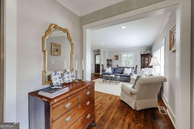 sitting room featuring visible vents, crown molding, baseboards, recessed lighting, and dark wood-style flooring