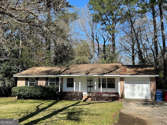 ranch-style house with brick siding, driveway, an attached garage, and a front lawn