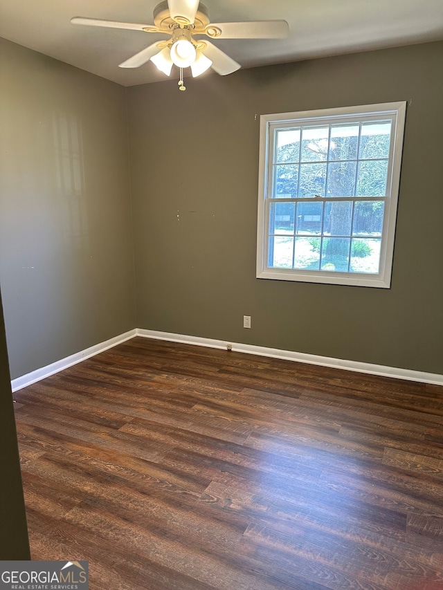 unfurnished room featuring wood finished floors, baseboards, and ceiling fan