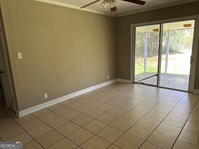 spare room featuring light tile patterned floors, ceiling fan, crown molding, and baseboards