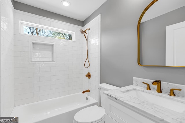 bathroom with vanity, toilet, and shower / tub combination