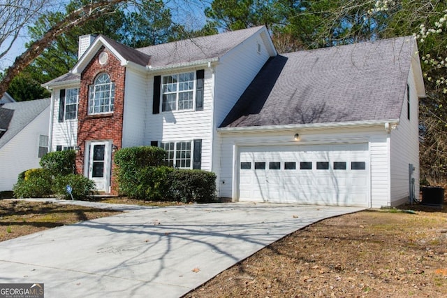 colonial home featuring driveway, an attached garage, brick siding, central AC unit, and a chimney