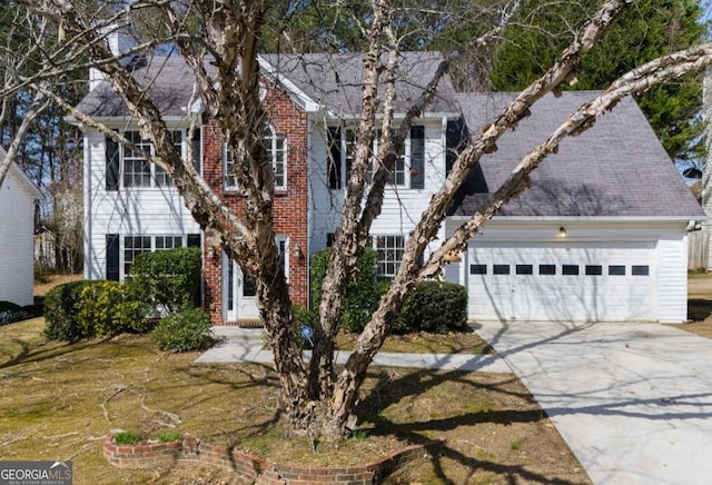 colonial inspired home with concrete driveway and a garage