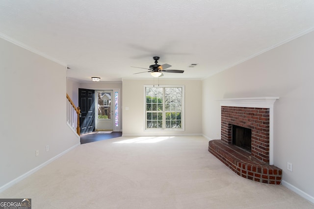 unfurnished living room with baseboards, carpet, stairs, ornamental molding, and a fireplace