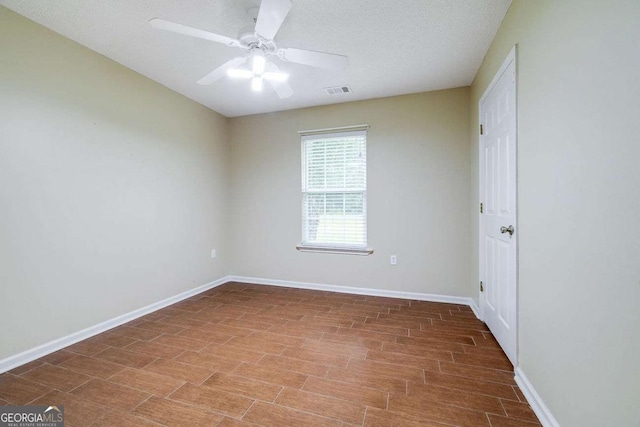 empty room with baseboards and a ceiling fan