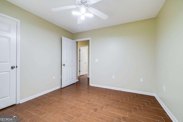 interior space with ceiling fan, baseboards, and wood finished floors