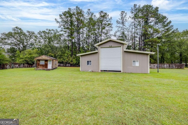 view of yard with an outbuilding and fence