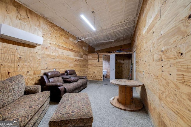 carpeted living area featuring wooden walls