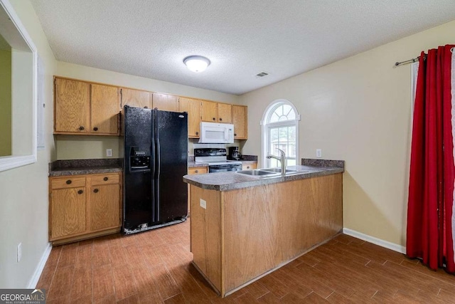 kitchen with white microwave, a peninsula, black refrigerator with ice dispenser, electric range, and a sink