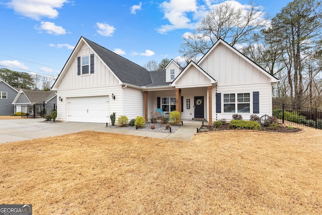 modern farmhouse style home featuring board and batten siding, a front lawn, fence, concrete driveway, and an attached garage