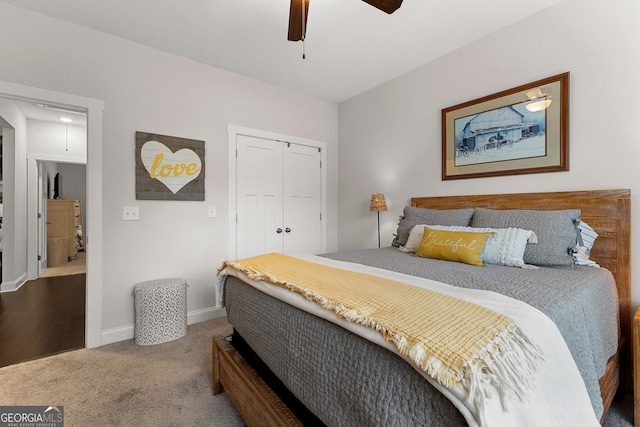 bedroom featuring a ceiling fan, a closet, carpet, baseboards, and attic access