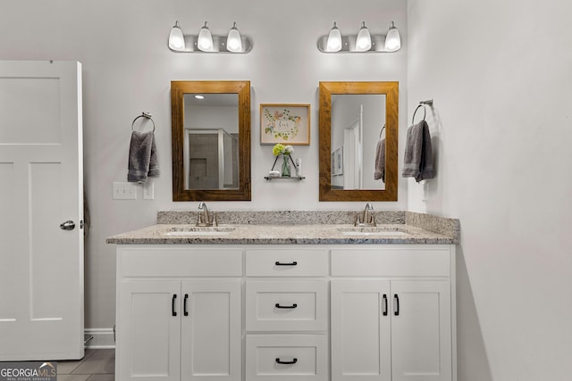 full bathroom featuring double vanity and a sink