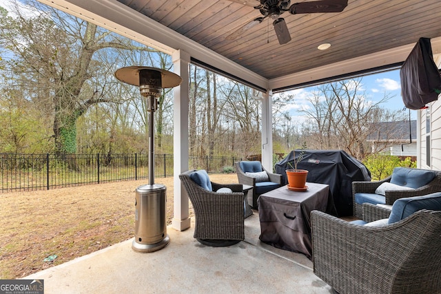 view of patio / terrace with an outdoor living space, area for grilling, a fenced backyard, and ceiling fan