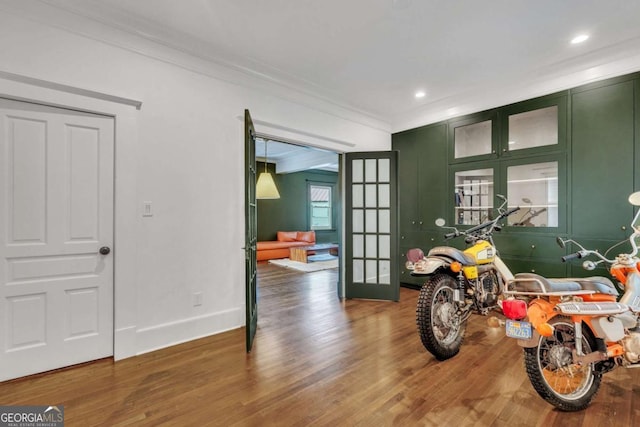 interior space featuring recessed lighting, french doors, wood finished floors, and ornamental molding