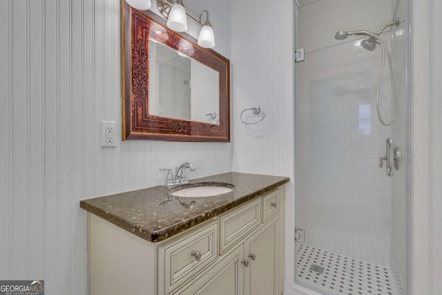 full bath with a stall shower and vanity