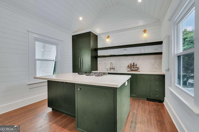 kitchen with open shelves, dark wood-style flooring, lofted ceiling, and green cabinetry