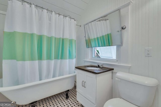 bathroom featuring shower / tub combo with curtain, toilet, and vanity