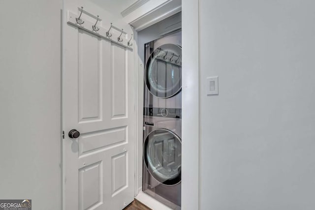 laundry room with stacked washer / drying machine and laundry area