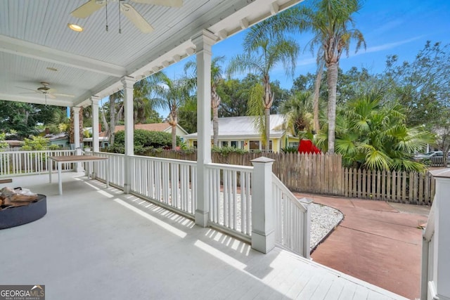 view of patio with covered porch, a ceiling fan, and fence