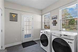 laundry area featuring laundry area, washer and dryer, and baseboards