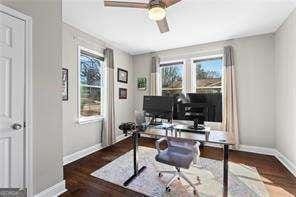 home office featuring a wealth of natural light, baseboards, ceiling fan, and wood finished floors