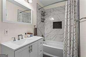 bathroom featuring vanity and shower / tub combo with curtain