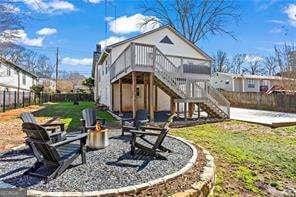 back of house featuring a patio, stairway, a fenced backyard, and a wooden deck