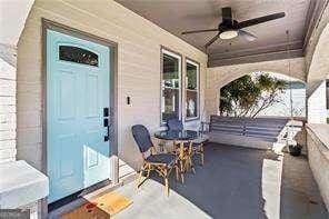 doorway to property with a porch and ceiling fan