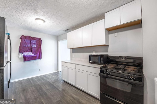 kitchen with black appliances, dark wood finished floors, light countertops, and white cabinetry