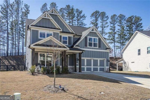 craftsman-style home with concrete driveway, an attached garage, board and batten siding, and central AC